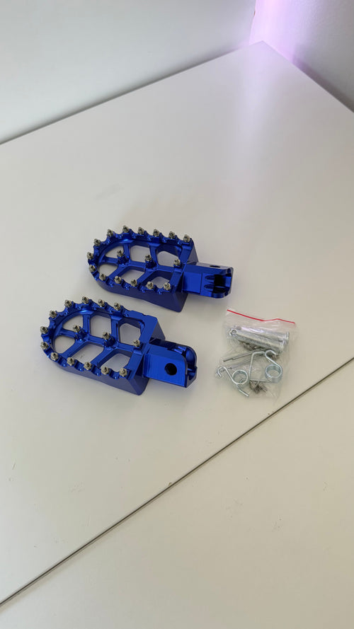 Blue Altis Delta foot pegs with mounting hardware pictured