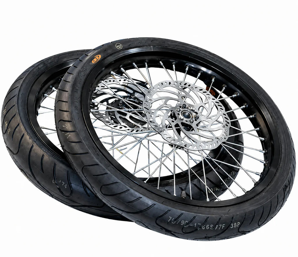 Black supermoto wheel and tire pair with silver spokes and brake rotors pictured