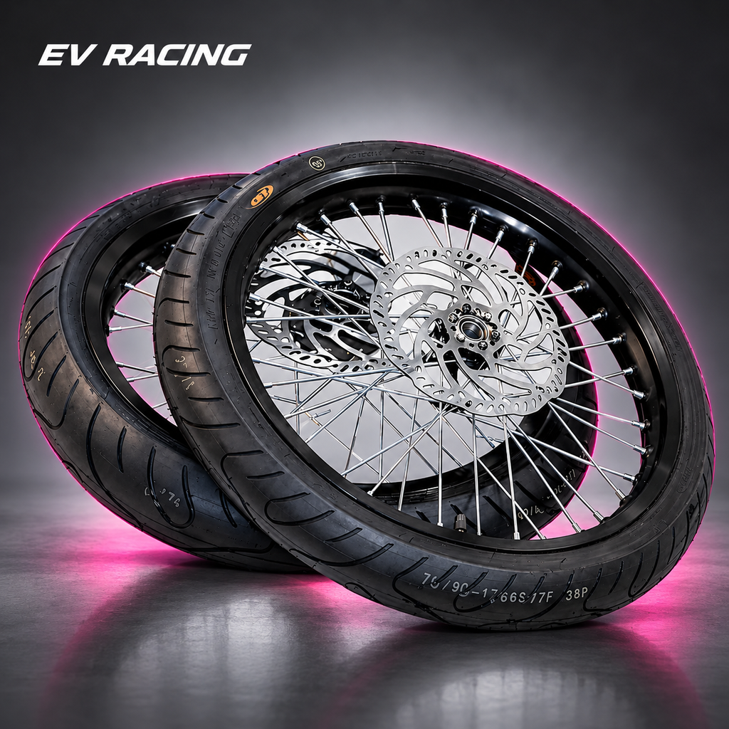 Black 17-inch supermoto wheel set on a gray studio background with pink accents
