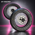 Surron Ultra Bee 17-Inch Supermoto Wheel Set on a gray studio background with pink accents; pictured brake rotors and sprocket are not included
